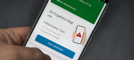 Corona warning app on a smartphone displays the test result - Incorrect - German words on the pictureの写真素材