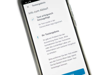 Corona warning app on a smartphone displays the test result - Incorrect - German words on the pictureの写真素材