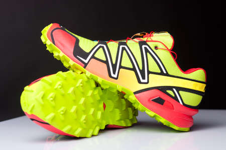 Two trail shoes on white table and black backgroundの写真素材
