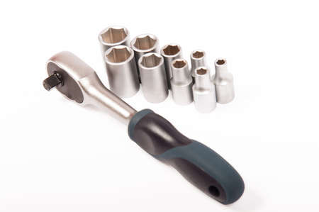 Ratchet wrench with matching fittings on white background