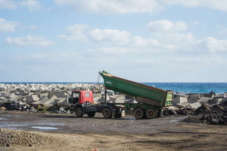 Truck in a quarry of land near the seaの写真素材