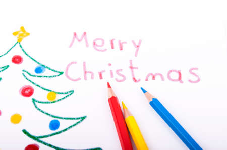Christmas tree drawn with color pencil on white paperの写真素材