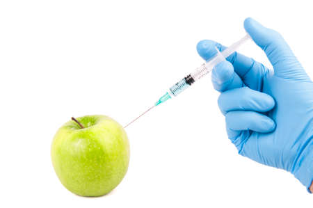 injecting genetic modification on a green appleの写真素材