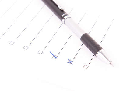 A pen on a questionnaire with boxes marked yes and noの写真素材