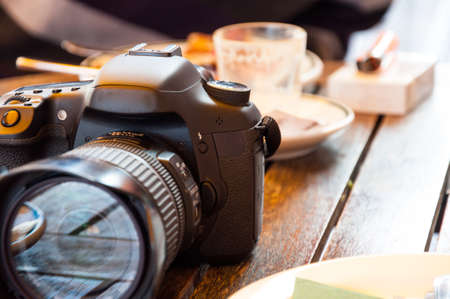 Photo camera on a table after eatingの写真素材