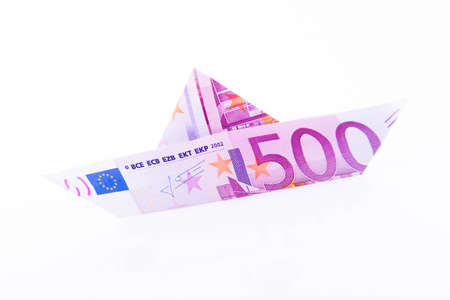 Paper boat made with a 500 euro note on white backgroundの写真素材