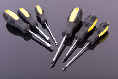 Professional screwdrivers set on a black tableの写真素材