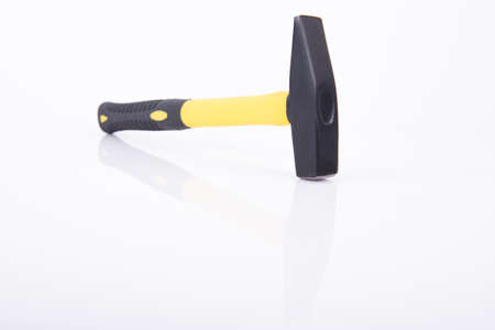 Black and yellow hammer with reflections on white background