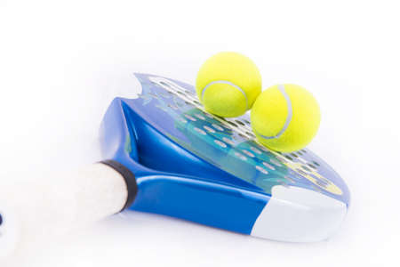 White and blue racket paddle with two balls on white backgroundの写真素材