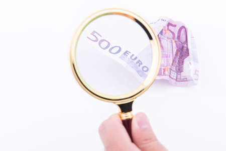 Revisiting a five hundred euro note creased and false on white backgroundの写真素材