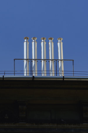 roof chimney on a residential building under blue sky in budapestの写真素材