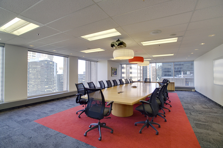 Executive modern empty business high rise office conference room overlooking a cityの写真素材