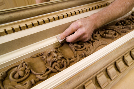 Closeup of a man's hand sanding woodwork.の写真素材
