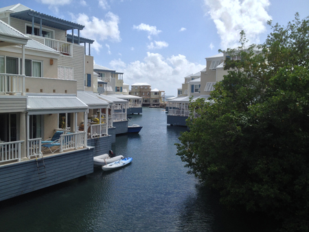 White and blue Caribbean houses over water with boats at dock. British Virgin Islandsのeditorial素材