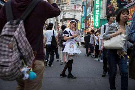 Tokyo, Japan; June 14 2016: a girl offering a discount for a maid cafe in Akihabaraのeditorial素材