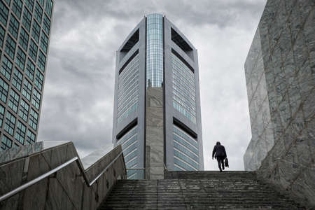Business man. A solitary business man walking on his way to the office shortly after rush hour.の写真素材