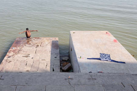 a boy beside the river ganges in Varanasi, Indiaのeditorial素材