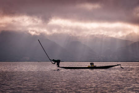 Intha fisherman posing with conical nets at sunset, Inle Lake in the Nyaungshwe Township part of Shan Hills in Myanmar Burmaの写真素材