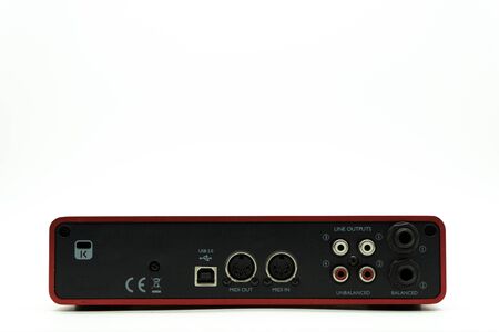USB Audio interface back view of the panel with plugs for connection, external sound card red color isolated on white backgroundの写真素材
