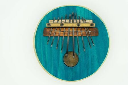 Blue Wooden ethnic African instrument Kalimba close up. Isolated on white background. Music concept.の写真素材