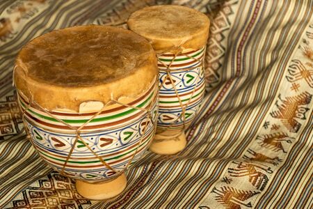 Horizontal view of Moroccan handmade bongos, made of ceramic and leather. Natural light. Concept of traditional instruments.の写真素材