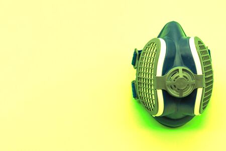 Radioactive green coronavirus mask, isolated on a yellow background with space for text. Concept virus. Covid-19.の写真素材