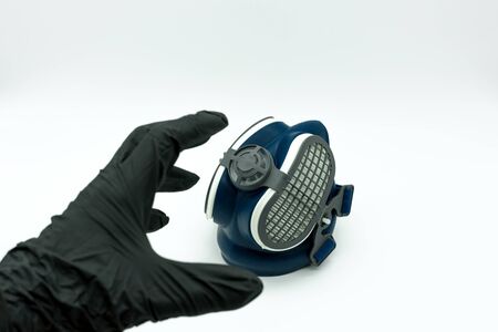 Hand with nitrile gloves holding a mask to fight the coronavirus. Concept covid-19.の写真素材