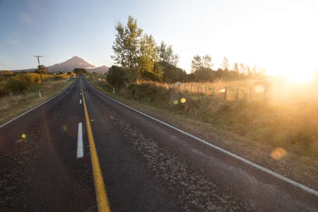 Wide angle view on Mount Taranaki (Mount Egmont) in New Zealand with road leading to it. Taken...