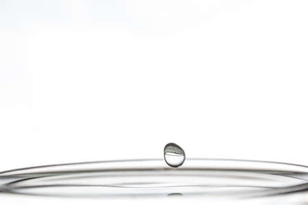 Drop of water about to hit the surfaceの写真素材