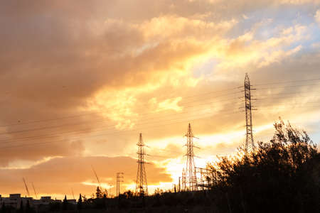 Electricity pylon at sunset with a dramatic sky.の写真素材