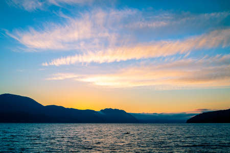 Sea and mountains at sunset shoot from the city of Volda, Norway.の写真素材