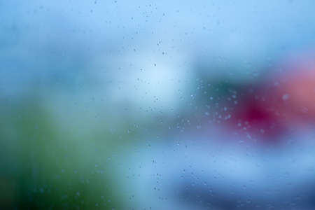Waterdrops in a window with a colorful background.