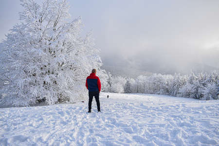 Man stands in winter mountains. Winter landscapeの写真素材
