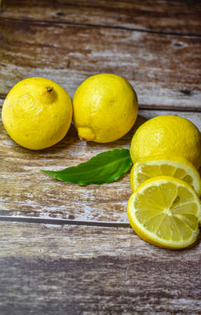 Whole lemon and slice of lemon with leaf. Healthy conceptの写真素材