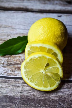 Lemon slice on wooden background. Fruit with a lot of vitamin cの写真素材