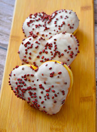Sweet baked hearts on wooden backgroundの写真素材