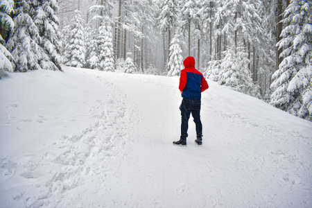 Man stands in snow on mountains during winter