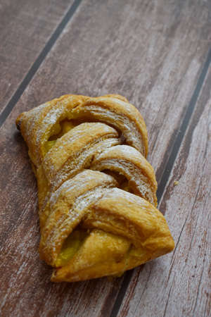 Small pie isolated on wooden backgroundの写真素材