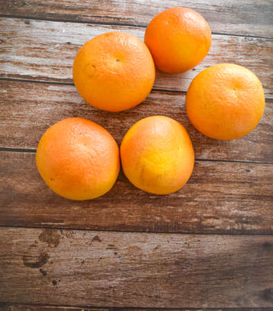 Grapefruits on wooden background in kitchen