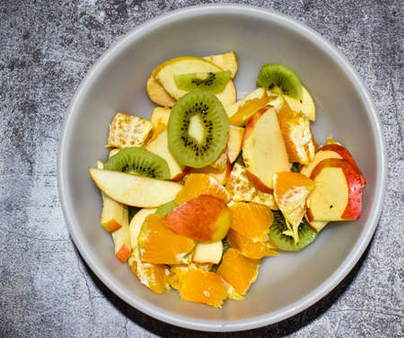 Fresh fruit salad in bowl, top viewの写真素材