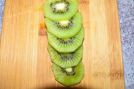 Kiwi slice on desk, healthy lifestyleの写真素材