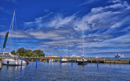 Sailboat harbor, many beautiful moored sail yachts in the sea port, modern water transport, summertime vacation, luxury lifestyle and wealth conceptのeditorial素材