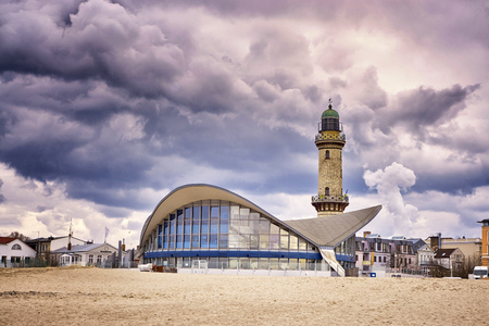 Teepott and lighthouse under dramatic clouds in Warnemnde.のeditorial素材