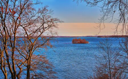 Small island with trees in the distance on the Schwerin lake.