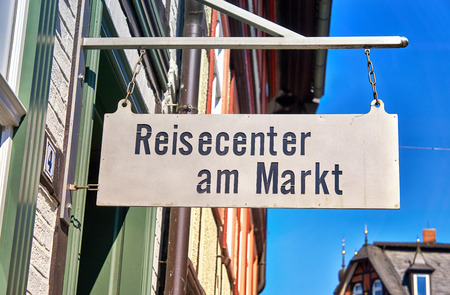 Old sign with the text Travel Agency. In German Reisecenter am Markt.のeditorial素材