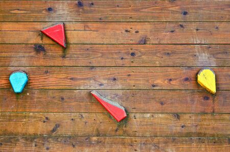 Wooden climbing wall with colorful handles as a background.の写真素材