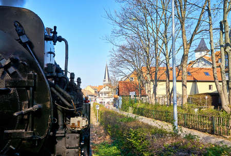 Steam locomotive drives through the city center of Wernigerode. Dynamic due to motion blur.