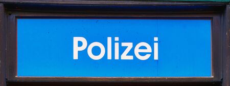 Old blue police station sign as text in German letters in a frame.の写真素材