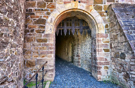 Stone wall with trap gate in Wernigerode Castle.のeditorial素材