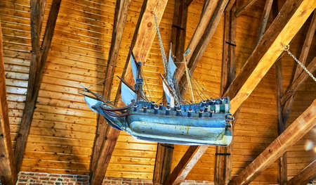 Wooden ship floats under the roof in an old seafarers church in Poland on the Baltic Sea.の写真素材
